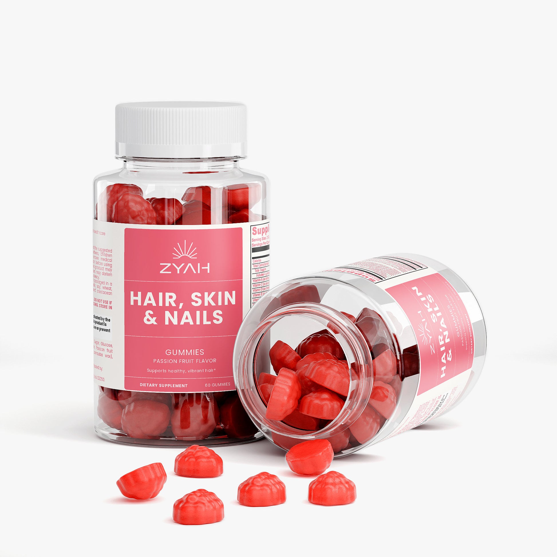 Zyah hair, skin, and nails gummy supplement bottles with red gummies on a white background