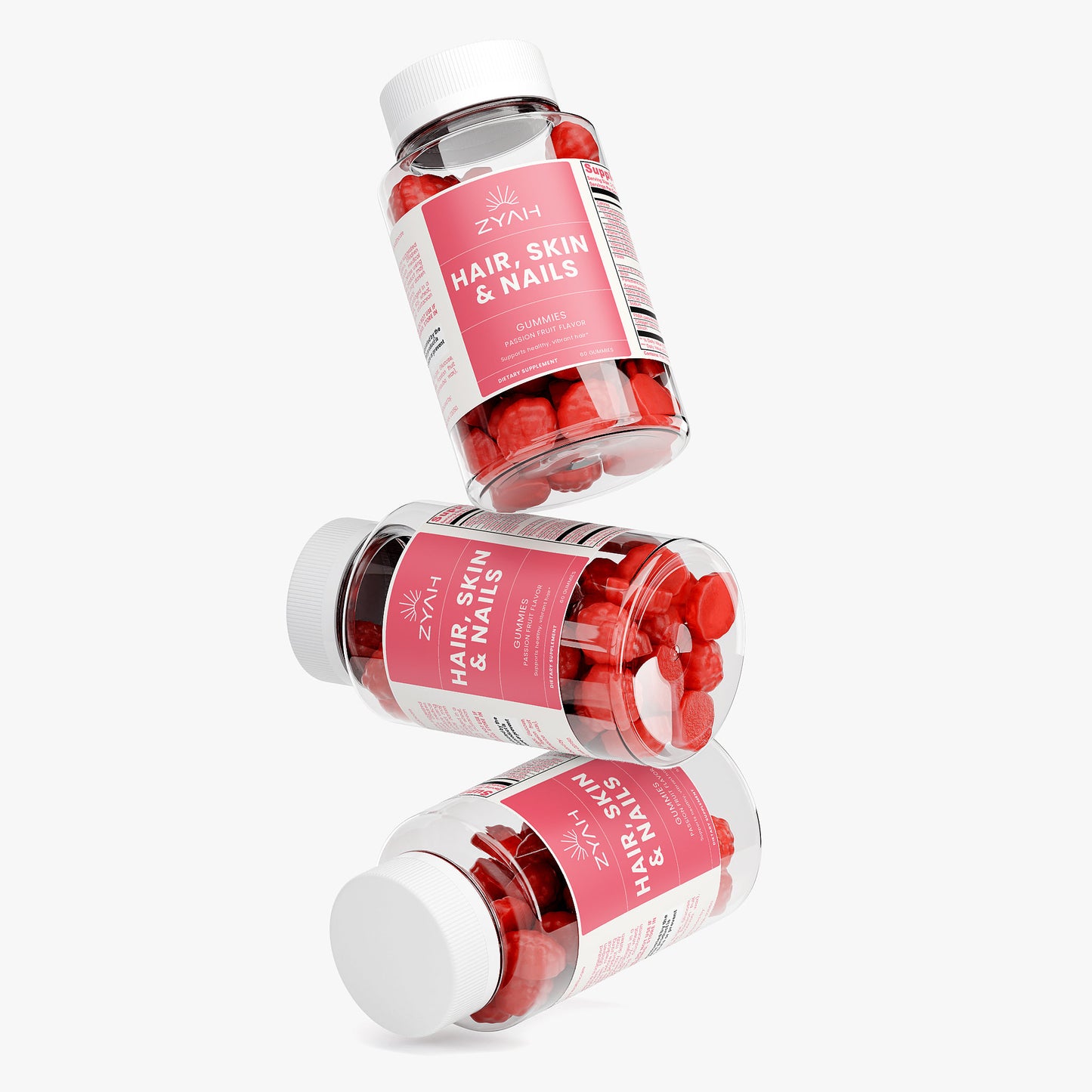 Three bottles of Zyam hair, skin, and nails supplements on a white background