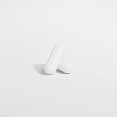 White ceramic vase on a light gray background