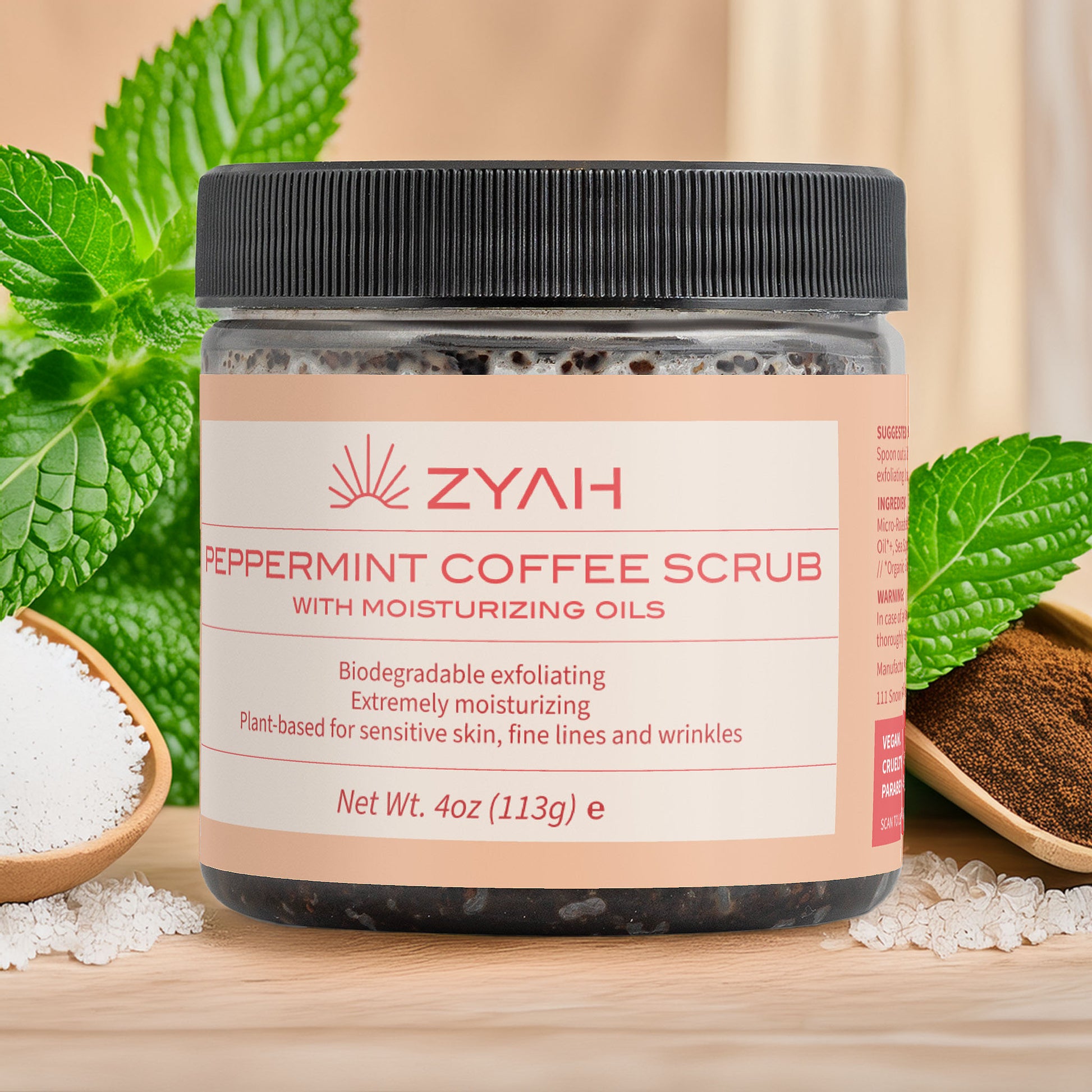 Jar of ZYAH Peppermint Coffee Scrub with ingredients on a wooden surface